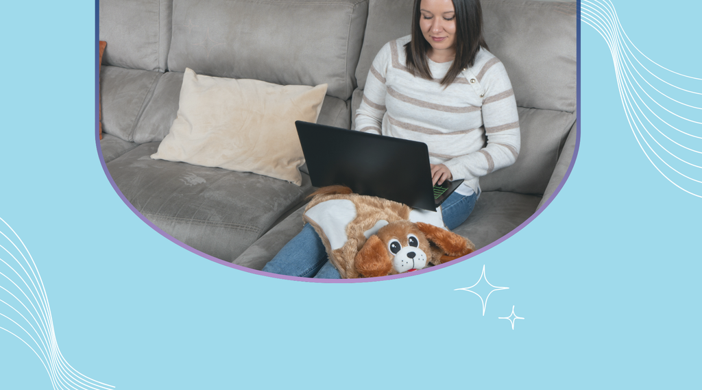 A woman sat on her lap top shopping online with Glowy the Dog on her lap